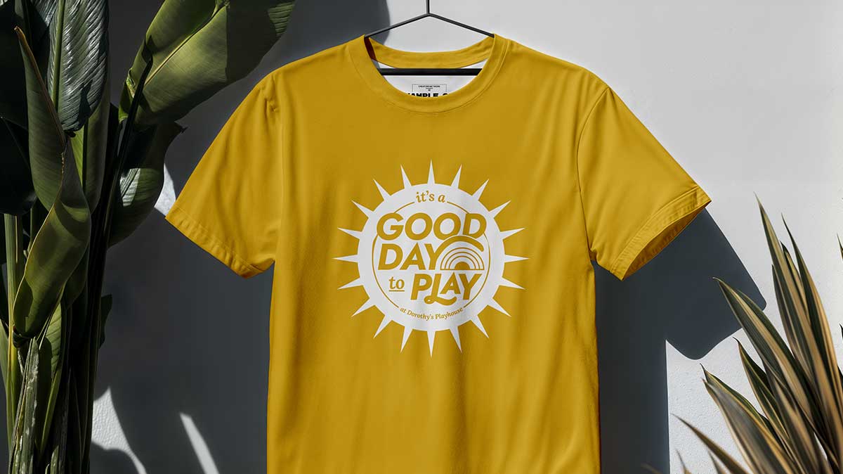 Yellow Tshirt with sun design and letters that say "it's a good day to play!"