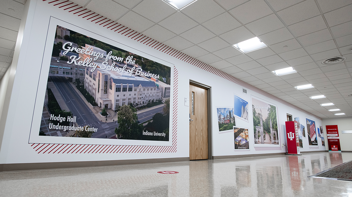 White wall with pinstripes and postcards with images of campus and Bloomington, Indiana