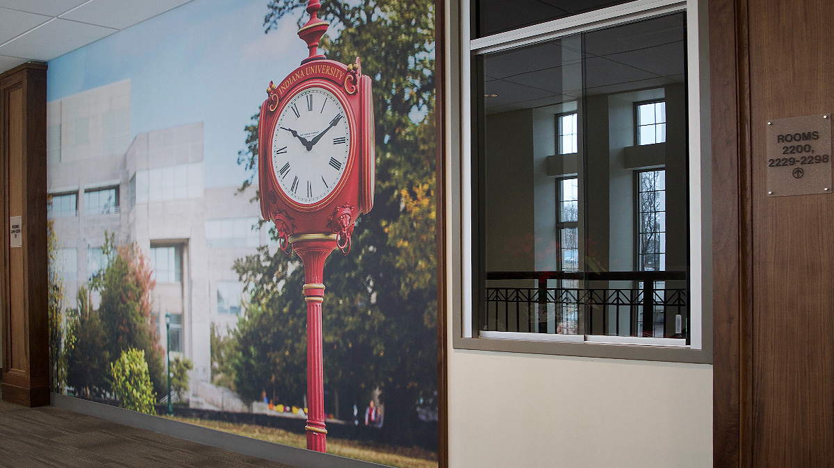 Large wall graphic showing the Indiana University clock