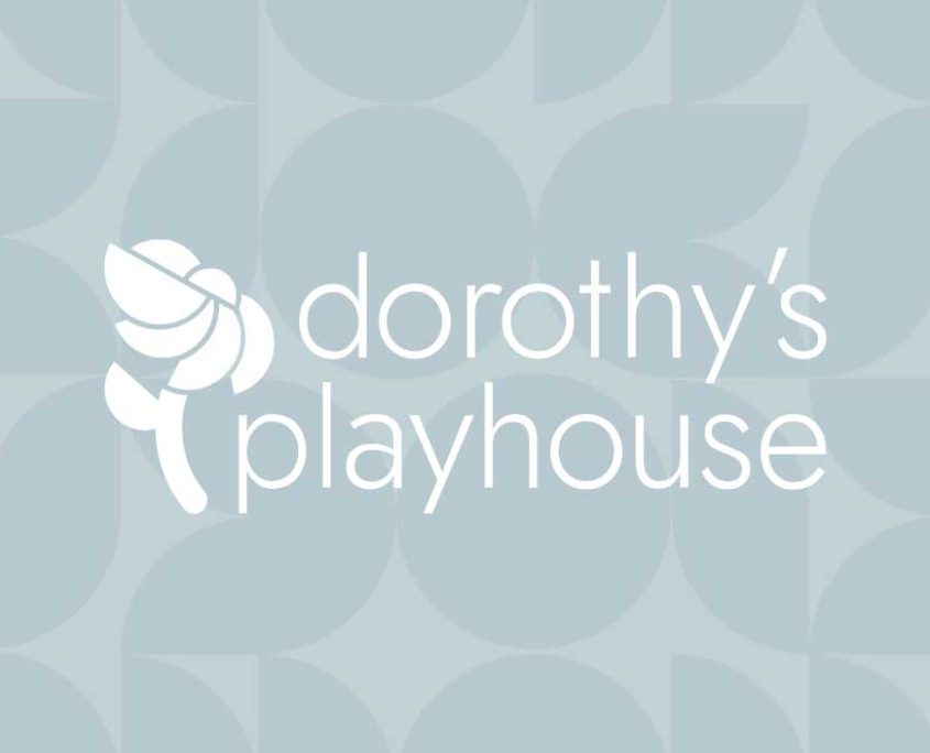 Dorothy's Playhouse logo design with white flower and bauhaus geometric patterned blue background